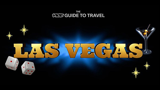 the VICE guide to travel in 3D gold lettering floating over a blue and black background with white dice and a martini glass
